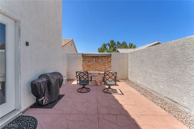 690 Great Dane Ct, Henderson, NV 89052 - fenced backyard with a grill and a patio area