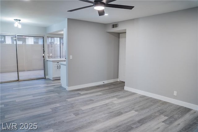 1440 Vegas Valley Dr Unit 3, Las Vegas, NV 89169 - spare room with ceiling fan, light wood-style flooring, and baseboards