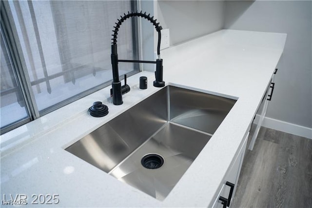 1440 Vegas Valley Dr Unit 3, Las Vegas, NV 89169 - kitchen view of a sink, dark wood-style flooring, and baseboards