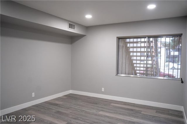 1440 Vegas Valley Dr Unit 3, Las Vegas, NV 89169 - unfurnished room with wood finished floors, baseboards, and recessed lighting