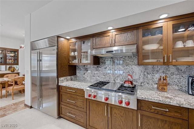 2925 Coast Line Ct, Las Vegas, NV 89117 - kitchen featuring stainless steel appliances, under cabinet range hood, tasteful backsplash, light stone countertops, and recessed lighting