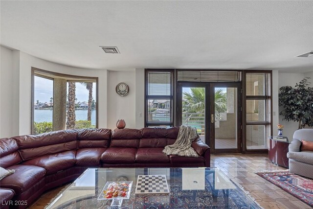 2925 Coast Line Ct, Las Vegas, NV 89117 - living area featuring a water view and a textured ceiling