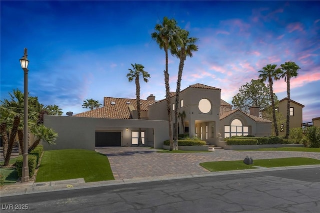 2925 Coast Line Ct, Las Vegas, NV 89117 - mediterranean / spanish home featuring stucco siding, a tiled roof, a chimney, driveway, and a garage
