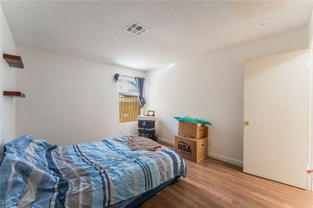 4335 Twin Peaks Dr, North Las Vegas, NV 89032 - bedroom featuring wood finished floors and a textured ceiling