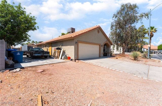 4335 Twin Peaks Dr, North Las Vegas, NV 89032 - view of front of home with stucco siding, an attached garage, concrete driveway, and a tile roof