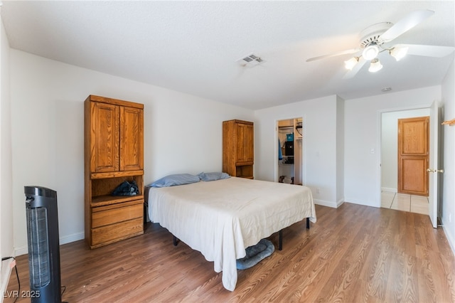 4335 Twin Peaks Dr, North Las Vegas, NV 89032 - bedroom featuring wood finished floors, ceiling fan, a closet, and a spacious closet