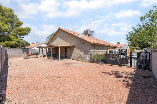 4335 Twin Peaks Dr, North Las Vegas, NV 89032 - rear view of property featuring stucco siding, a tile roof, and a fenced backyard