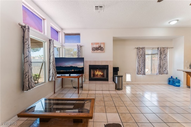 4335 Twin Peaks Dr, North Las Vegas, NV 89032 - tiled living room featuring a tile fireplace and a textured ceiling