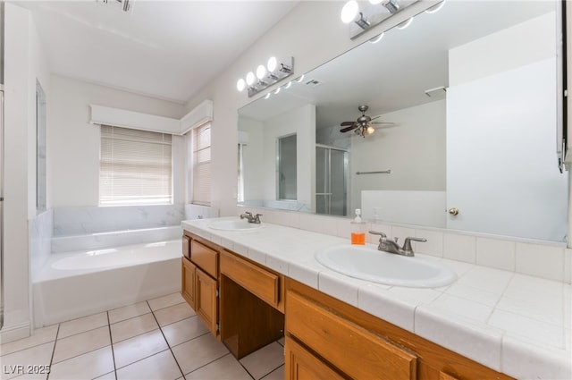 4335 Twin Peaks Dr, North Las Vegas, NV 89032 - bathroom with a garden tub, double vanity, a stall shower, tile patterned floors, and a ceiling fan