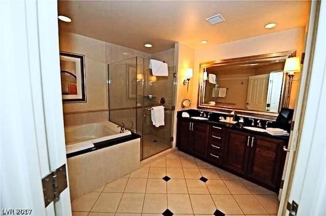 125 E Harmon Ave Unit 1918, Las Vegas, NV 89109 - full bathroom with double vanity, a garden tub, tile patterned floors, a stall shower, and recessed lighting