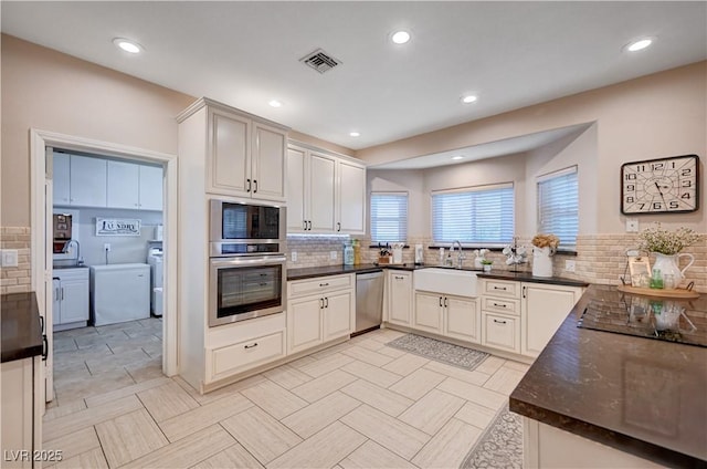 6821 Jeanette St, Las Vegas, NV 89131 - kitchen with stainless steel appliances, a sink, decorative backsplash, recessed lighting, and washer / dryer