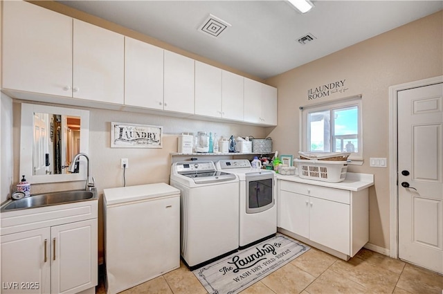 6821 Jeanette St, Las Vegas, NV 89131 - laundry room featuring separate washer and dryer, cabinet space, and light tile patterned flooring