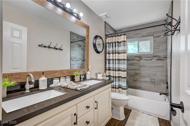 6821 Jeanette St, Las Vegas, NV 89131 - full bath with double vanity, shower / bath combination with curtain, toilet, and wood finished floors
