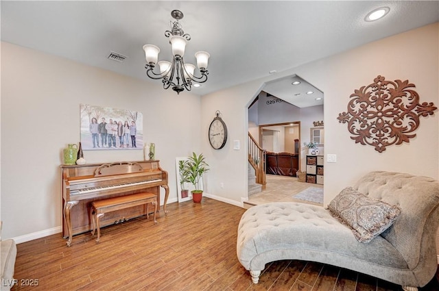 6821 Jeanette St, Las Vegas, NV 89131 - living area with arched walkways, wood finished floors, recessed lighting, a chandelier, and baseboards