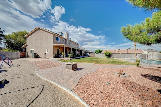 6821 Jeanette St, Las Vegas, NV 89131 - back of house with a fire pit, a patio area, and stucco siding