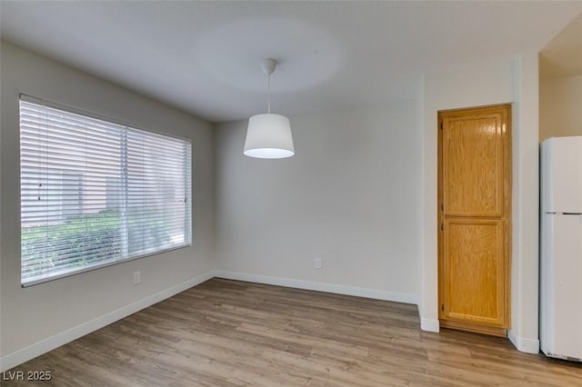 350 S Durango Dr Unit 103, Las Vegas, NV 89145 - unfurnished dining area with light wood finished floors and baseboards