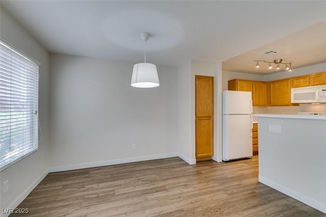 350 S Durango Dr Unit 103, Las Vegas, NV 89145 - kitchen with white appliances, plenty of natural light, light wood finished floors, and light countertops