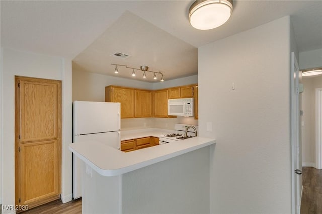 350 S Durango Dr Unit 103, Las Vegas, NV 89145 - kitchen with white appliances, wood finished floors, light countertops, and a peninsula