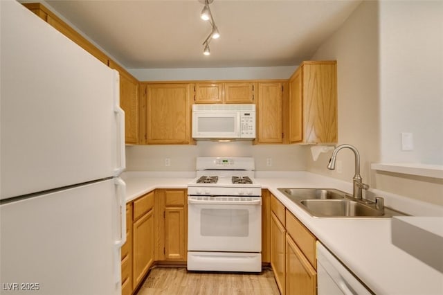 350 S Durango Dr Unit 103, Las Vegas, NV 89145 - kitchen featuring white appliances, a sink, light wood-style floors, and light countertops