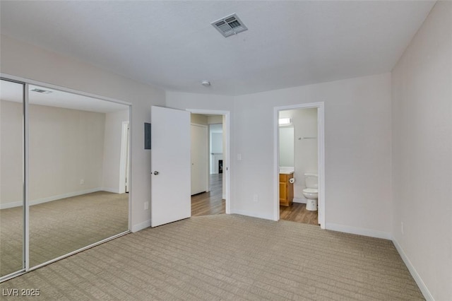 350 S Durango Dr Unit 103, Las Vegas, NV 89145 - unfurnished bedroom featuring light colored carpet, baseboards, a closet, and ensuite bathroom
