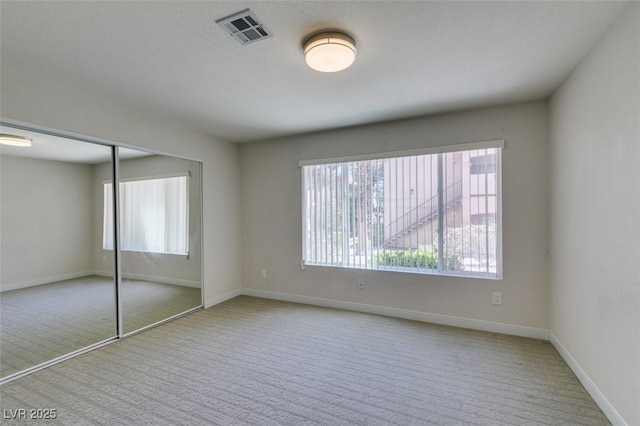 350 S Durango Dr Unit 103, Las Vegas, NV 89145 - unfurnished bedroom with carpet floors, multiple windows, and baseboards