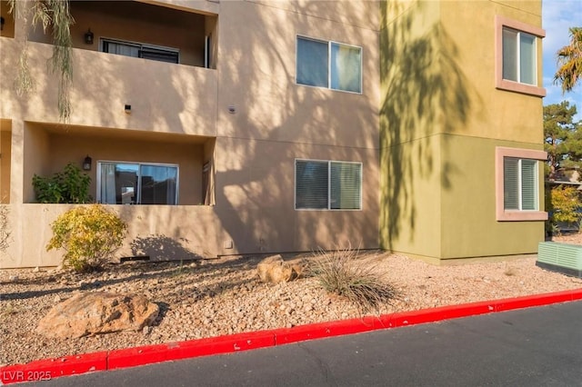 1812 N Decatur Blvd Unit 103, Las Vegas, NV 89108 - view of side of home featuring stucco siding