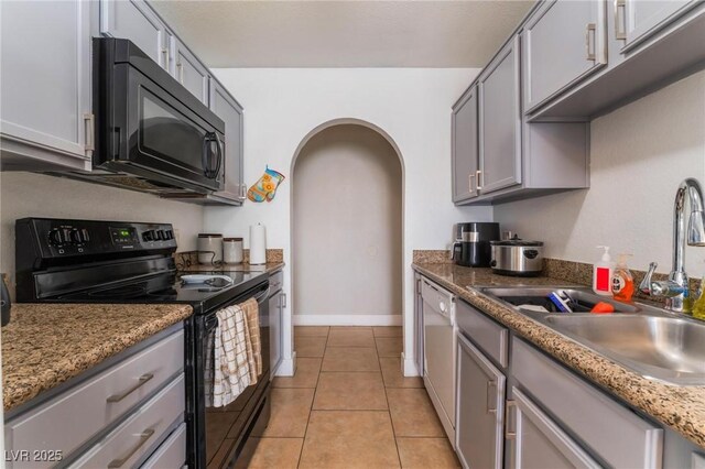 1812 N Decatur Blvd Unit 103, Las Vegas, NV 89108 - kitchen with black appliances, arched walkways, gray cabinets, and light tile patterned floors