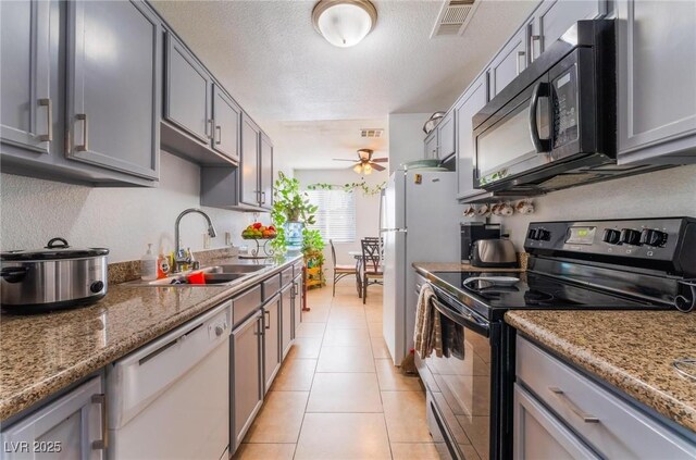 1812 N Decatur Blvd Unit 103, Las Vegas, NV 89108 - kitchen with electric stove, dishwasher, black microwave, ceiling fan, and a textured ceiling