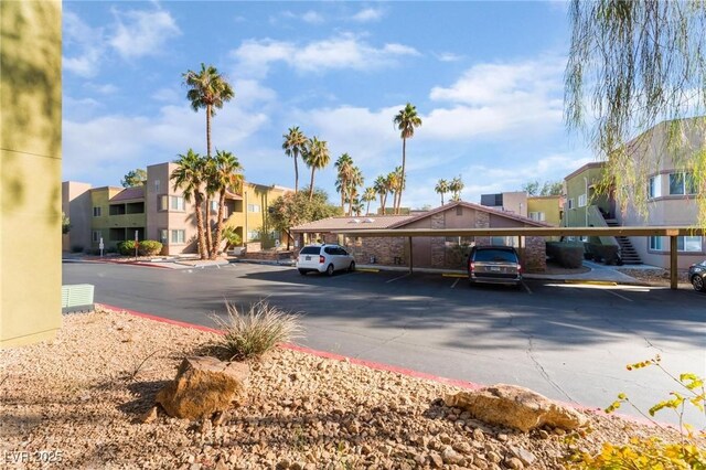 1812 N Decatur Blvd Unit 103, Las Vegas, NV 89108 - partially covered parking lot featuring a residential view
