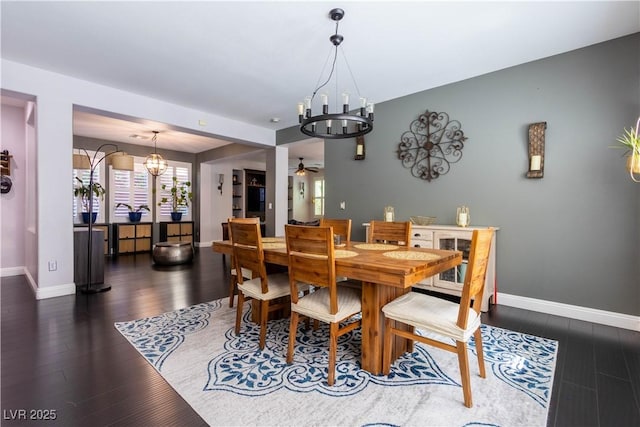 10526 Harvest Wind Dr, Las Vegas, NV 89135 - dining space featuring a chandelier, baseboards, a ceiling fan, and healthy amount of natural light