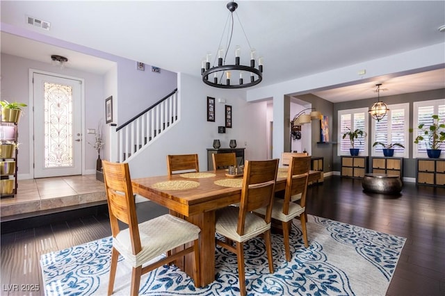 10526 Harvest Wind Dr, Las Vegas, NV 89135 - dining space with a chandelier, wood finished floors, baseboards, and stairway