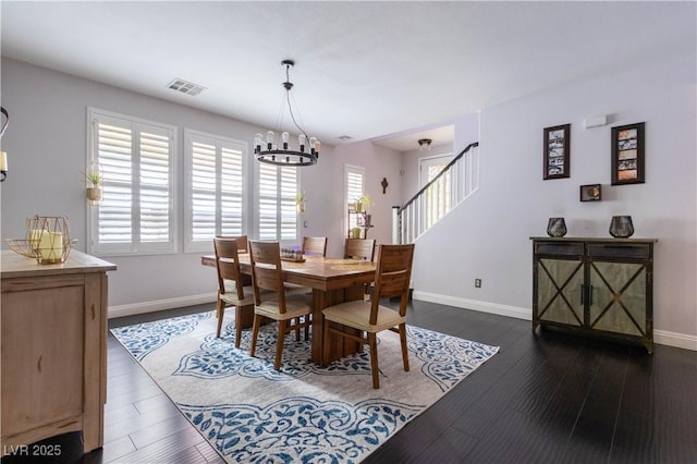10526 Harvest Wind Dr, Las Vegas, NV 89135 - dining space with a chandelier, baseboards, dark wood-style flooring, and stairway