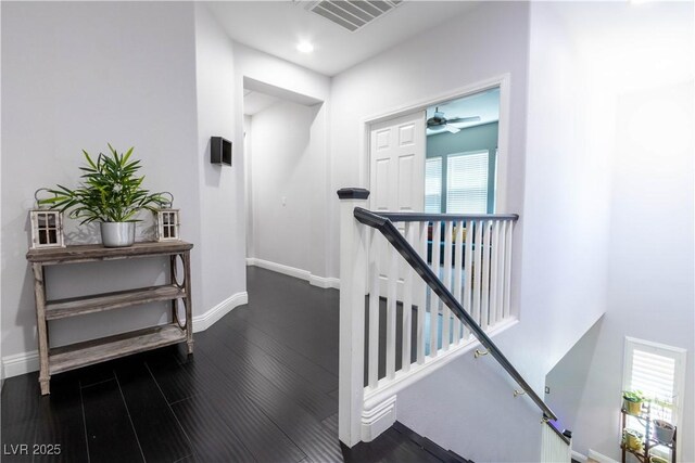 10526 Harvest Wind Dr, Las Vegas, NV 89135 - hallway featuring an upstairs landing, dark wood-type flooring, baseboards, and recessed lighting