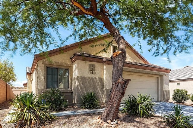 5605 Midnight Breeze St, North Las Vegas, NV 89081 - view of front of property with an attached garage, stucco siding, and driveway