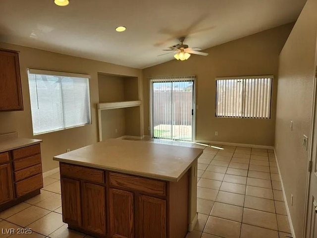 5605 Midnight Breeze St, North Las Vegas, NV 89081 - kitchen featuring lofted ceiling, a ceiling fan, light tile patterned floors, built in shelves, and light countertops