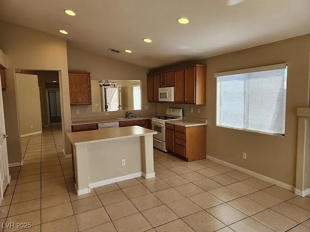 5605 Midnight Breeze St, North Las Vegas, NV 89081 - kitchen with white appliances, light countertops, plenty of natural light, recessed lighting, and light tile patterned floors
