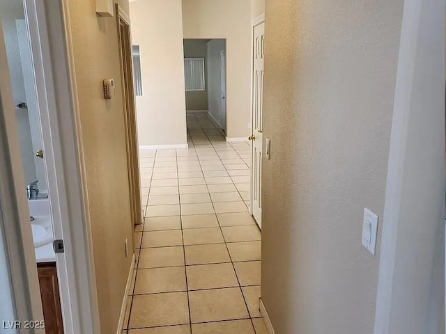 5605 Midnight Breeze St, North Las Vegas, NV 89081 - hall featuring light tile patterned floors and baseboards