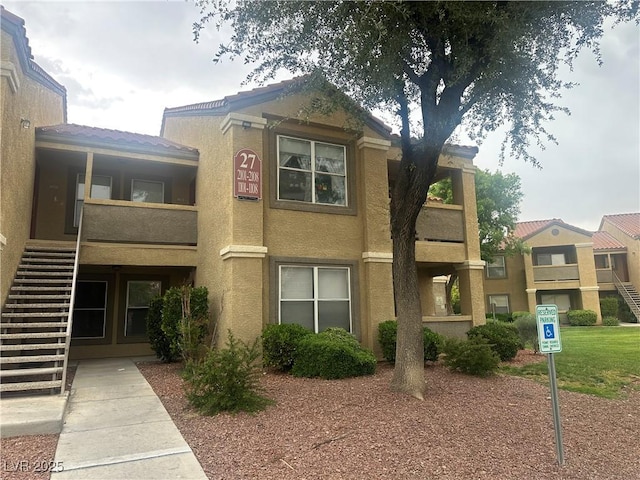 2300 E Silverado Ranch Blvd Unit 1104, Las Vegas, NV 89183 - view of front of home featuring stairway and stucco siding