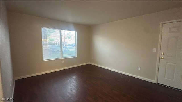 2300 E Silverado Ranch Blvd Unit 1104, Las Vegas, NV 89183 - empty room featuring dark wood finished floors and baseboards