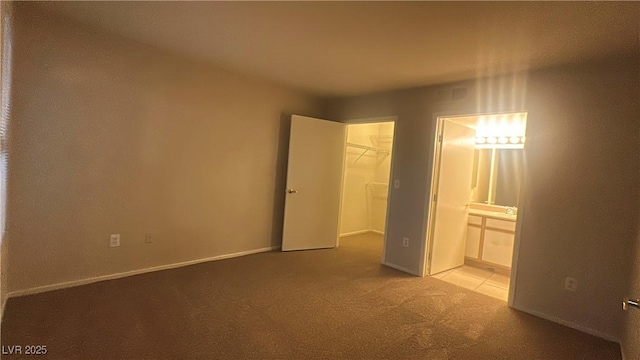 2300 E Silverado Ranch Blvd Unit 1104, Las Vegas, NV 89183 - unfurnished bedroom featuring carpet, a spacious closet, ensuite bathroom, and a closet