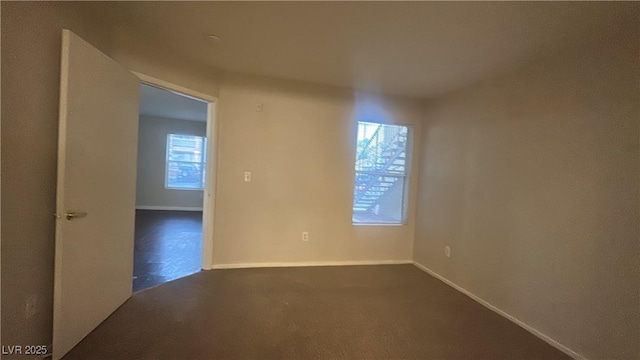 2300 E Silverado Ranch Blvd Unit 1104, Las Vegas, NV 89183 - empty room with dark colored carpet and baseboards