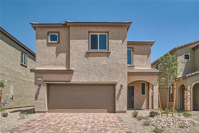 9842 Lost Horse Ave, Las Vegas, NV 89178 - view of front facade with a garage, stucco siding, and decorative driveway