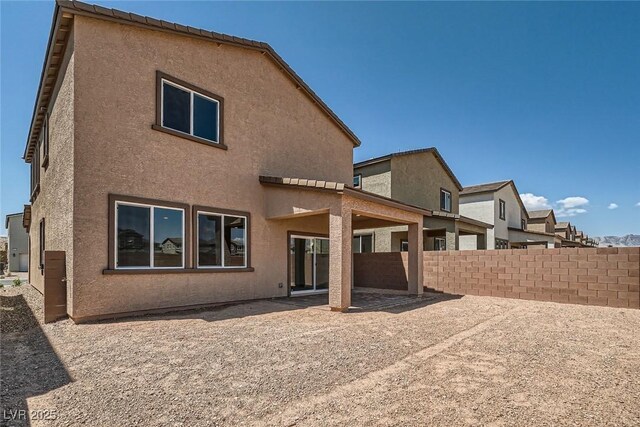 9842 Lost Horse Ave, Las Vegas, NV 89178 - back of property with stucco siding and a patio area