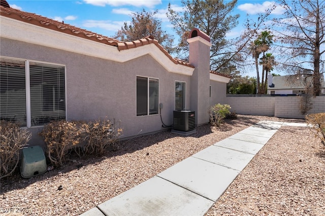 1838 N Jones Blvd, Las Vegas, NV 89108 - view of side of property featuring central AC unit, stucco siding, and a tile roof