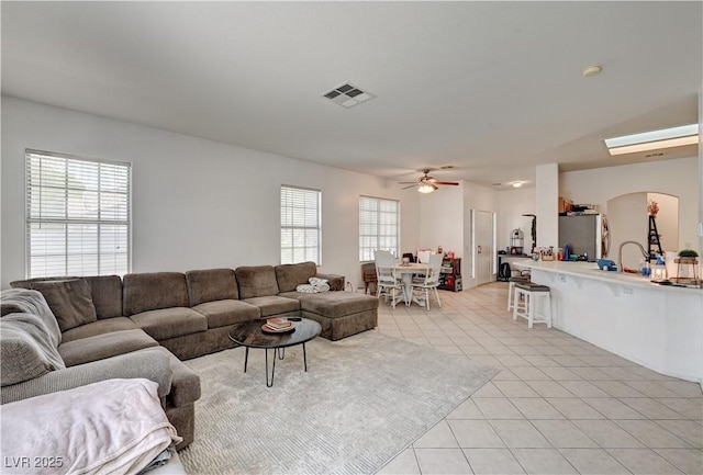 7616 Yondering Ave, Las Vegas, NV 89131 - living room featuring healthy amount of natural light, light tile patterned floors, and a ceiling fan