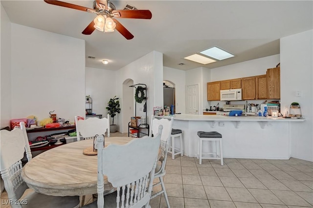 7616 Yondering Ave, Las Vegas, NV 89131 - dining room with arched walkways, ceiling fan, and light tile patterned floors