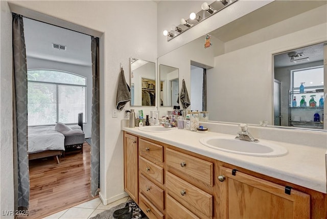 7616 Yondering Ave, Las Vegas, NV 89131 - ensuite bathroom with double vanity and tile patterned floors