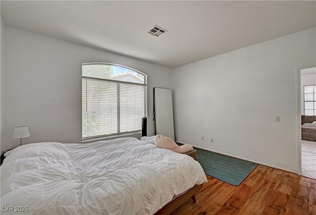 7616 Yondering Ave, Las Vegas, NV 89131 - bedroom with wood finished floors and multiple windows