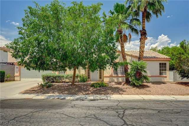 7616 Yondering Ave, Las Vegas, NV 89131 - view of front of property featuring a tiled roof, concrete driveway, and stucco siding