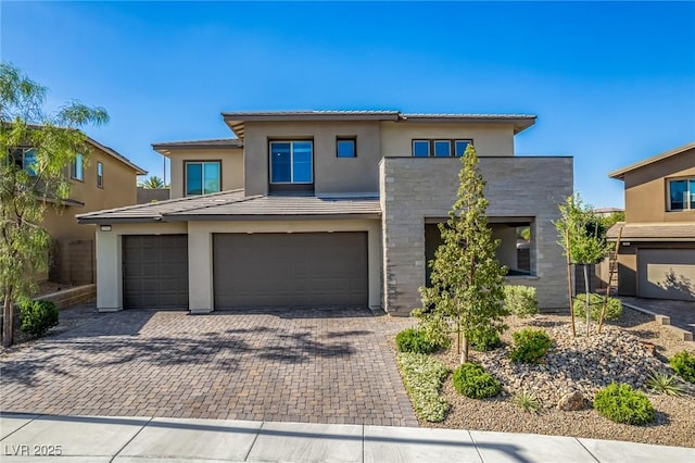 12332 Switchgrass Ave, Las Vegas, NV 89138 - view of front of property with an attached garage, stucco siding, decorative driveway, and a tile roof